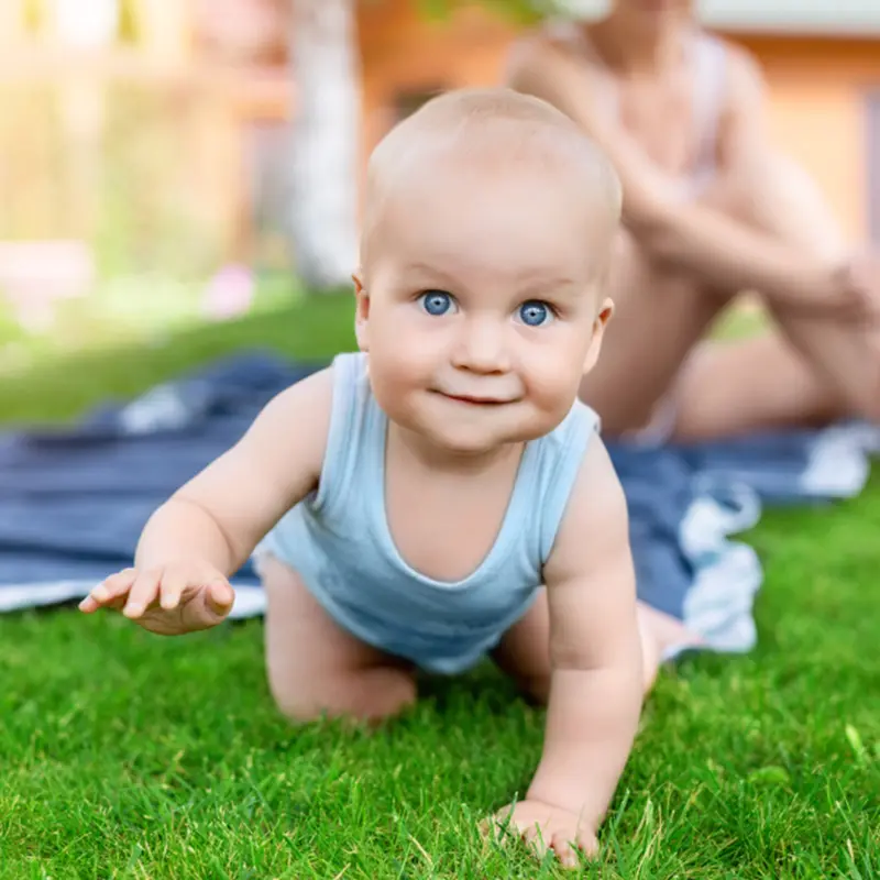 Baby smiling and crawling - Lake Sammamish Kids Dentistry