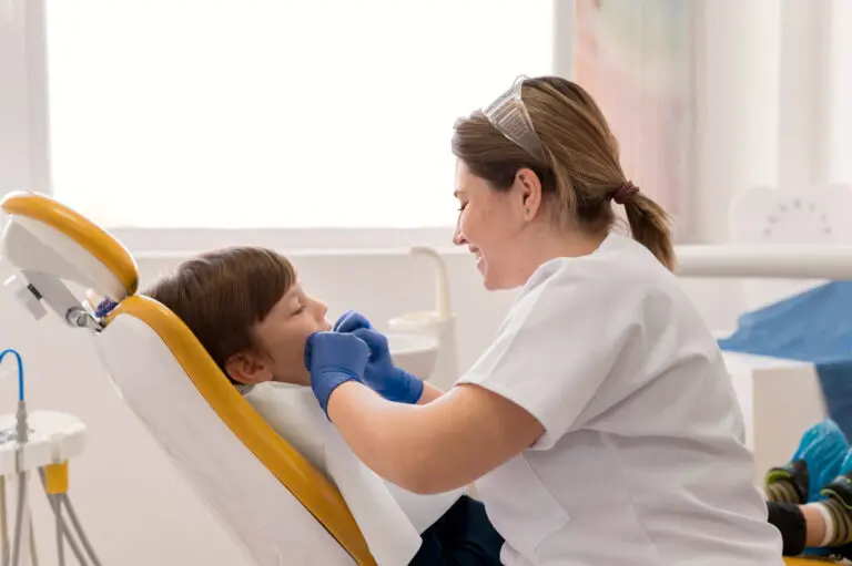 At Lake Sammamish Kids Dentistry - Pediatric Dentist in Sammamish WA, a dentist examines a young boy's teeth in a bright clinic, emphasizing the value of preventive pediatric dental care and regular cleanings for children.