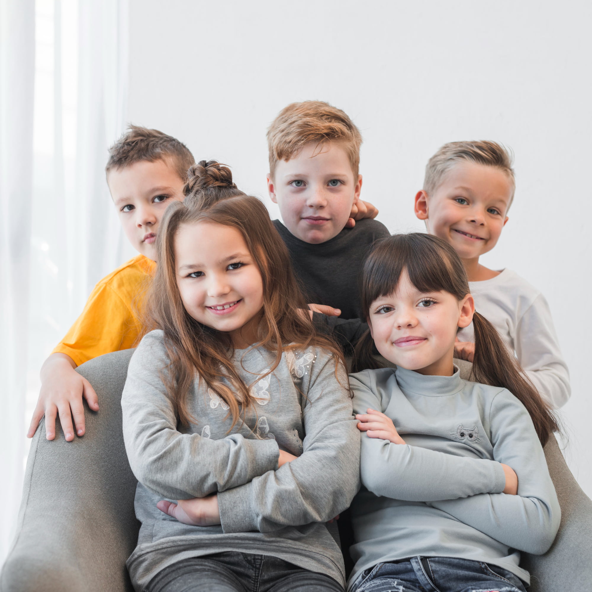 Five smiling children, three boys and two girls, looking at the camera. This represents Lake Sammamish Kids Dentistry - Pediatric Dentist in Sammamish WA, and its community resources for children's dental health and well-being.